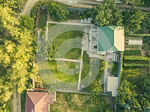Aerial drone shot of summer countryside cottage with garden f