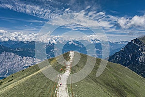 Aerial drone shot of tourists hikers and paragliders on top of Monte Baldo in Lake Garda Area