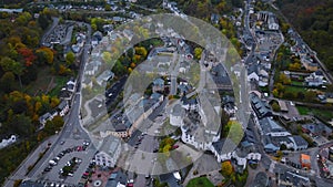 Aerial drone shot of town CLervaux on the north of Luxembourg. Twilight evening scene with Castle and Cathedral