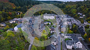 Aerial drone shot of town CLervaux on the north of Luxembourg. Twilight evening scene with Castle and Cathedral