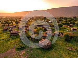 Aerial Drone Shot. Traditional Masai village at Sunset time near Arusha, Tanzania