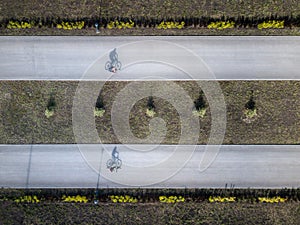 Aerial drone shot of two bike rining trough the park