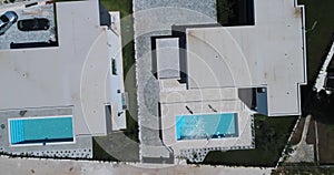 Aerial drone shot of two identical vacation homes or villas with sea view.