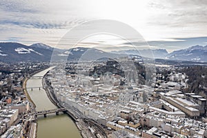 Aerial drone shot view of Salzburg Salzach river and Hohensalzburg fortress Untersberg snow mountain