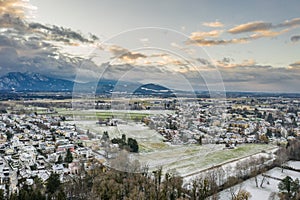 Aerial drone shot view of snowy villages outside Salzburg outskirt during sunset hour