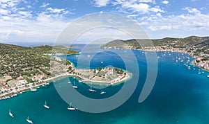 Aerial drone shot of Vis Island port with St. Jeronima church and Adriatic coastline in summer photo