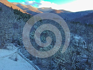 Aerial Drone snowy winter view of Blue Ridge Mountains in Asheville, North Carolina. Snow in the Appalachian Mountains.