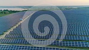 Aerial drone top shot of solar cells at clean energy station with sunlighting. Concept of renewable sun energy, power