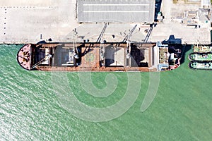 Aerial drone top view of containers cargo ship at industrial import-export port. Business logistic import and export freight