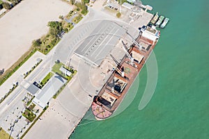 Aerial drone top view of containers cargo ship at industrial import-export port. Business logistic import and export freight