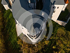 Aerial drone top view of Slovenska Lupca castle during autumn sunset