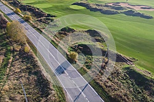 Aerial drone vibrant view of golf course in countryside, landscape field with with a rich green turf and sand bunkers summer sunny