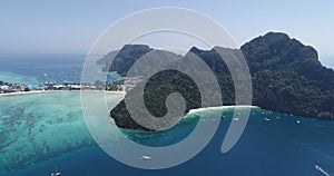 Aerial drone video of iconic tropical beach and resorts on Phi Phi island and Yong Kasem Bay called Monkey beach