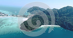 Aerial drone video of iconic tropical beach and resorts on Phi Phi island and Yong Kasem Bay called Monkey beach