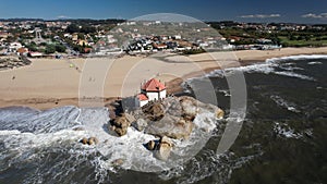 Aerial drone view of 18th century baroque Senhor da Pedra church in Miramar beach, Gulpilhares, Portugal