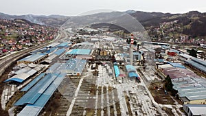 Aerial Drone view of an abandoned factory. Old industrial complex. Industrial halls, buildings and chimney. Industry