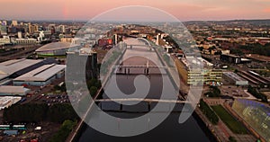 Aerial drone view, along the River Clyde, in Glasgow skyline at sunset. Views over city and landmarks. 4k