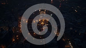 Aerial drone view of the ancient gothic Church of Our Lady before Tyn in the Old Town square covered in snow at night