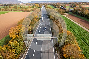 Aerial drone view on autobahn and autumn colorful landscape