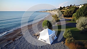 Aerial drone view of beach tent campsite by the sea, scenic overview for outdoor enthusiasts