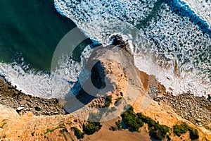 Aerial drone view of beautiful Atlantic ocean coastline and cliff in Praia de Ribeira d'Ilhas in Ericeira, Portugal