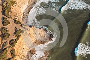 Aerial drone view of beautiful Atlantic ocean coastline and cliff in Praia de Ribeira d'Ilhas in Ericeira, Portugal