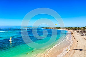 Aerial drone view of beautiful caribbean tropical beach with palms and straw umbrellas. Bavaro, Punta Cana, Dominican Republic. photo