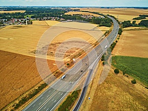 Aerial drone view of beautiful French countryside and six-lane motorway in France