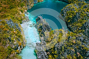 Aerial drone view of a beautiful tropical Big Lagoon at Miniloc Island, El Nido, Philippines. Tourist kayaking