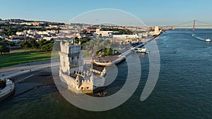 Aerial drone view of Belem Tower on the bank of the Tagus River at sunset. Lisbon, Portugal