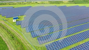 Aerial Drone view of Blue Solar panel farm or solar power plant. Alternative renewable energy with photovoltaic cell industry