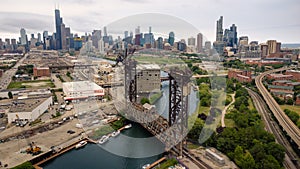 Aerial drone view of a boat sailing on the Chicago river under a bridge