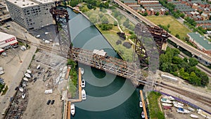 Aerial drone view of a boat sailing on the Chicago river under a bridge