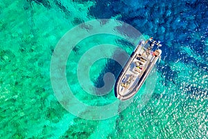 Aerial drone view of a boat with turquoise water. Ionian sea, Kefalonia Island, Greece