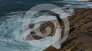 Aerial Drone View of Bride Woman in an White Dress on a Rocky Cliff