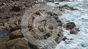 Aerial Drone View of Bride Woman in an White Dress on a Rocky Cliff