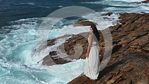 Aerial Drone View of Bride Woman in an White Dress on a Rocky Cliff