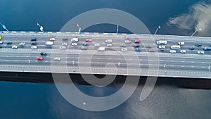 Aerial drone view of bridge road automobile traffic jam of many cars from above, city transportation