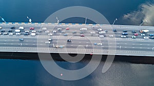 Aerial drone view of bridge road automobile traffic jam of many cars from above, city transportation