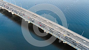 Aerial drone view of bridge road automobile traffic jam of many cars from above, city transportation