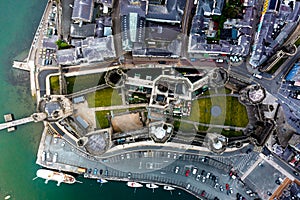 Aerial drone view of Caernarfon castle and battlements along the River Seiont in North Wales