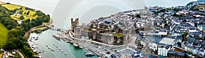 Aerial drone view of Caernarfon castle and battlements along the River Seiont in North Wales