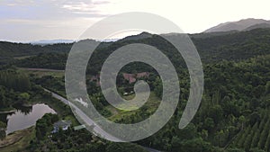 Aerial drone view of car driving on beautiful country road landscape