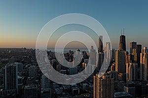 Aerial, drone view of Chicago downtown skyline and Lake Michigan during sunset