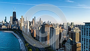 aerial drone view of Chicago metropolis from the lake during sunset