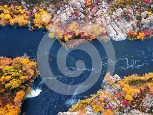 Aerial drone view of colorful forest, blue river and rocks. beautiful autumn landscape