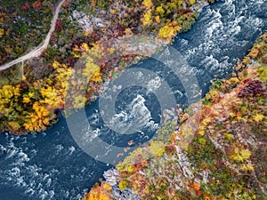 Aerial drone view of colorful forest, blue river and rocks. beautiful autumn landscape