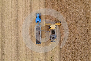 Aerial drone view of a combine harvester and tractor