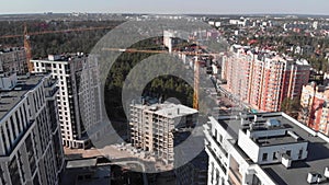 Aerial drone view of construction site with high tower crane at residential building complex. New house development. Modern housin