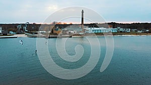 Aerial Drone View of a Corekites Kitesurfers Hydrofoiling  in Engure Port at in Baltic Sea